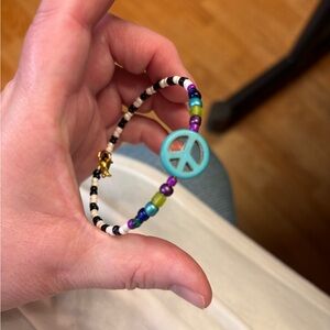 New hand beaded bracelet with peace sign black n white stripes bold colors
